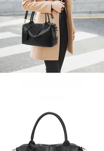 Detail of black leather Boston bag featuring gold zippers and an adjustable strap