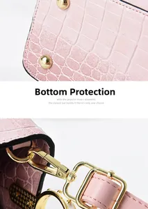 Detail of pink croc-embossed handbag showing bottom protective studs and gold hardware