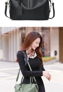 Detail of lychee pattern leather handbag with adjustable strap and decorative tag