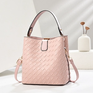 Pink woven bucket bag with leather texture and adjustable shoulder strap for casual wear