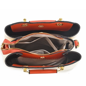 Internal view of crossbody handbag with triple compartments and golden zipper details