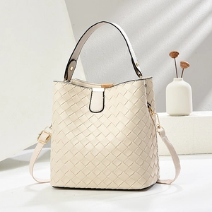 Elegant off-white woven bucket bag with top handle and adjustable shoulder strap