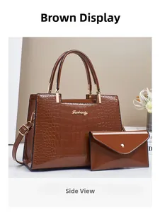 Detailed macro view of earth yellow crocodile embossed tote bag with small envelope pouch