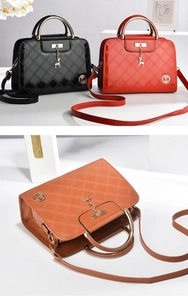 Close-up of patent leather diamond quilted texture with a gold deer charm detail