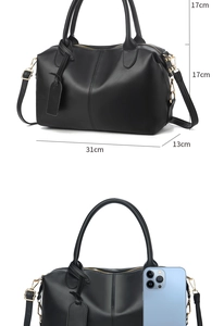 Size specifications and dimensions of a black faux leather boston handbag with gold hardware