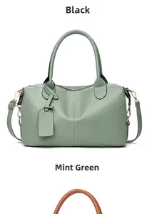 Detail of mint green faux leather handbag with gold hardware and lychee grain texture