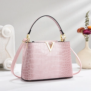Pink crocodile pattern tote bag with gold V logo and detachable shoulder strap