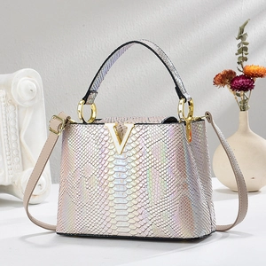 Iridescent snakeskin pattern handbag with gold V-hardware and versatile shoulder strap