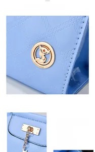 Close-up of sky blue patent leather bag with diamond quilting and gold fox logo hardware