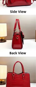 Detailansicht der roten Lackleder-Beuteltasche mit Krokoprägung und Schleifendetail