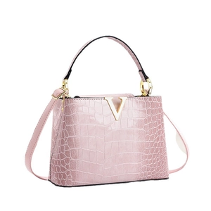 Pink crocodile-embossed leather handbag with gold V-hardware and top handle shoulder strap
