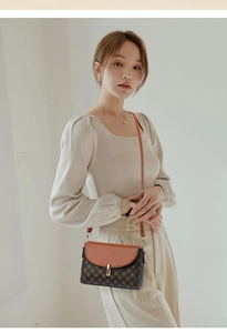 Detail of vintage square crossbody bag with brown monogram canvas and gold metal lock