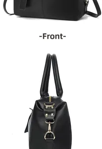 Detailed view of the black textured leather handbag featuring polished gold hardware and base