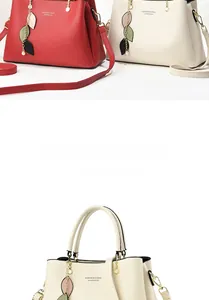 Detail of the litchi grain faux leather texture and decorative leaf charms on the handbag