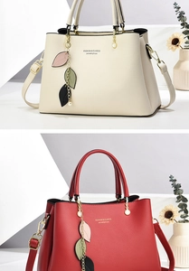 Detail view of lychee texture faux leather bag with elegant leaf and pearl charms