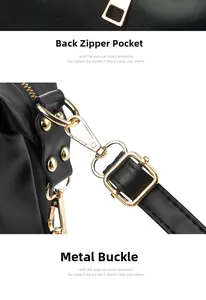 Detailed view of the back zipper pocket and golden hardware buckles on the black handbag