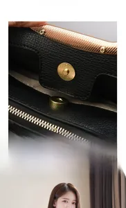 Close-up of golden magnetic buckle on black lychee leather handbag with shoulder strap
