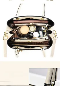 Spacious cream crossbody bag with multiple compartments showing ample interior storage