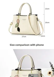 Size comparison of white crossbody bag with mobile phone and precise measurements