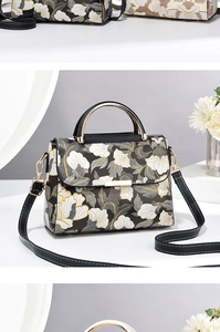Détail de la broderie florale vintage et de la boucle dorée sur le sac à main