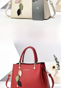 Macro view of lychee-textured leather surface with gold-stamped FASHION logo and leaf charm