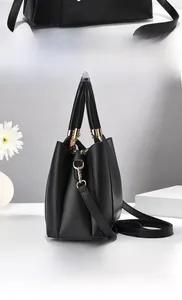 Detailed views of a black pebbled leather handbag with gold hardware and shoulder strap