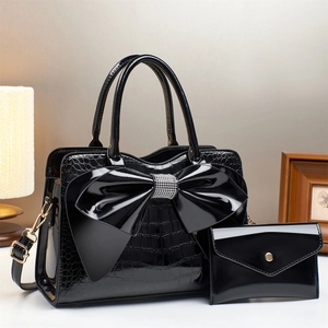 Elegant black crocodile patent leather handbag set with oversized bow and rhinestone detail