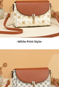 Detail view of the vintage white printed crossbody bag with golden hardware and floral patterns