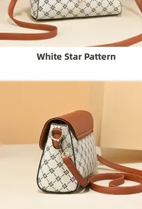 Detail of white starry pattern on vintage crossbody bag with brown leather strap