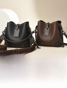 Detailed view of leather bucket bags featuring contrast nylon straps and M MMF tags
