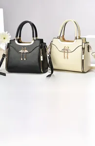 Detail view of stylish tote bags with swan metal hardware and decorative zippers