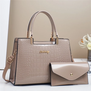 Detail of faux crocodile leather tote and envelope bag set with golden metal hardware