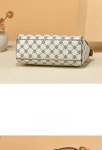 Detail view showing the reinforced rectangular bottom and geometric floral print of the bag