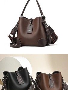 Close-up of pebble leather bucket bag with woven shoulder strap and MMF logo tag