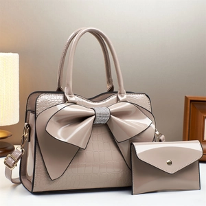 Beige patent leather handbag set with crocodile pattern and rhinestone bow detail