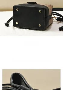 Vue détaillée du fond du sac seau avec pieds en métal doré et coutures en cuir premium