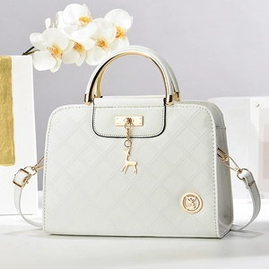 White rhombic embossed handbag with golden ring handle and a cute deer pendant