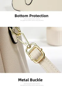 Detailed macro view of beige lychee leather stitching and gold hardware buckle
