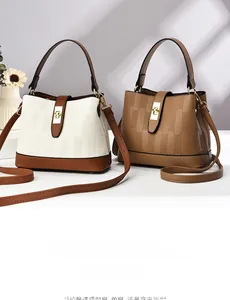 Close-up of stylish bucket bags featuring litchi texture and gold metal hardware