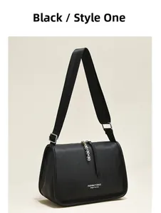 Detail of black lychee grain leather crossbody bag with wide strap and metallic zipper