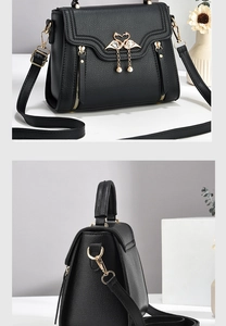 Detail of black lychee leather handbag featuring golden swan buckle and pearl tassel