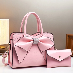 Pink patent leather bow tote and envelope clutch two-piece set with crocodile embossing