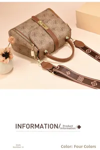 Close-up of vintage brown pattern Boston handbag with golden hardware and wide strap