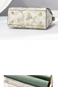 Détail de la broderie florale et pieds de protection en métal doré sur le sac à main