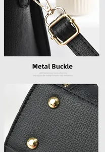 Detail of black lychee leather bag with golden adjustable buckle and bottom studs