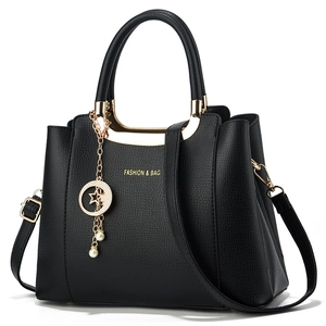 Classic black pebbled leather tote bag with gold handles and pearl star charm detail