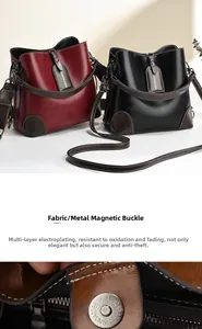Detail of magnetic buckle and polished leather on bucket bag with adjustable strap
