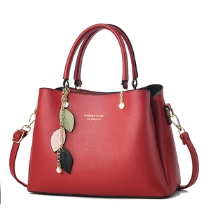 Elegant red leather handbag for women with dual top handles and detachable shoulder strap