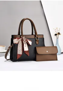 Detail of lychee textured leather tote with silk scarf handle and small clutch