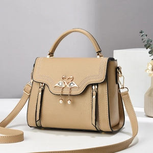 Elegant beige crossbody bag with swan metal buckle and decorative side zippers